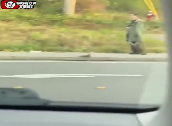 Video :He strolls with a dead raccoon while grinning